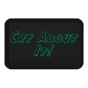 以下が含まれることがあります： 「Cry About It!」という緑色の文字が刺繍された黒いパッチ