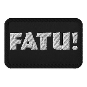 Puede incluir: Parche de tela negro con texto bordado en blanco que dice "FATU!"