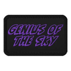May include: Purple embroidered patch on a black background with the text "Genius of the Sky".