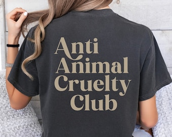 May include: A dark grey t-shirt with the text "Anti Animal Cruelty Club" printed in a light brown color on the back.