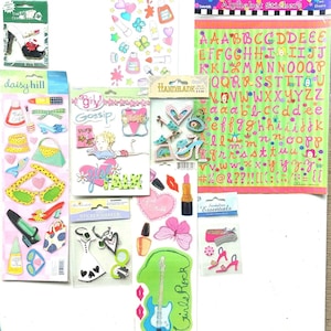 May include: Assortment of colorful sticker sheets with various themes, including girly gossip, pink stuff, and alphabet stickers. The sheets feature images of lips, butterflies, sunglasses, purses, and a guitar.