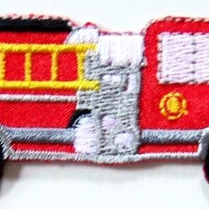 May include: Embroidered patch of a red fire truck with a yellow ladder, black wheels, and white and gray detailing. The patch has a black border and a small yellow emblem on the side. This patch is suitable for clothing or accessories.