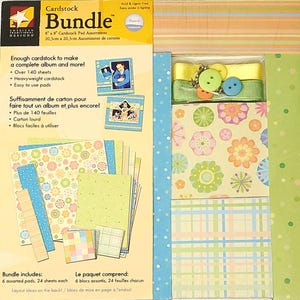 May include: Cardstock Bundle with 6 assorted pads, 24 sheets each. The bundle includes a variety of colorful patterned papers, including floral designs, polka dots, and plaid. The bundle also includes embellishments such as ribbons, buttons, and charms.