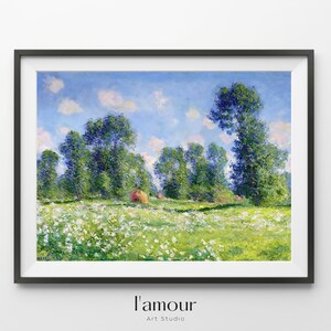 May include: Framed landscape art print depicting a field of white flowers, green grass, and tall green trees under a blue sky with clouds. The print is in a black frame. The text "l'amour Art Studio" is at the bottom.