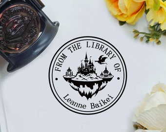May include: Black and white stamp with a castle, dragon, and the text "From the Library of Leanne Baiker".