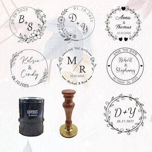 May include: A black self-inking stamp labeled Epress R-0040 and a wooden handle stamp with a brass base. Seven circular stamp impressions are displayed, featuring floral wreaths, names like B+S, D+Y, Anna & Thomas, Kelsie & Cindy, M/R, Robert & Stephany, and various dates.