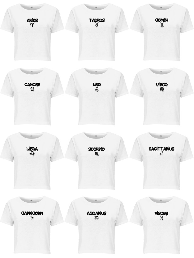 May include: A collection of twelve white short-sleeved t-shirts arranged in a grid. Each shirt features a black graphic print of a zodiac sign name and its corresponding astrological symbol, including Aries, Taurus, Gemini, Cancer, Leo, Virgo, Libra, Scorpio, Sagittarius, Capricorn, Aquarius, and Pisces.