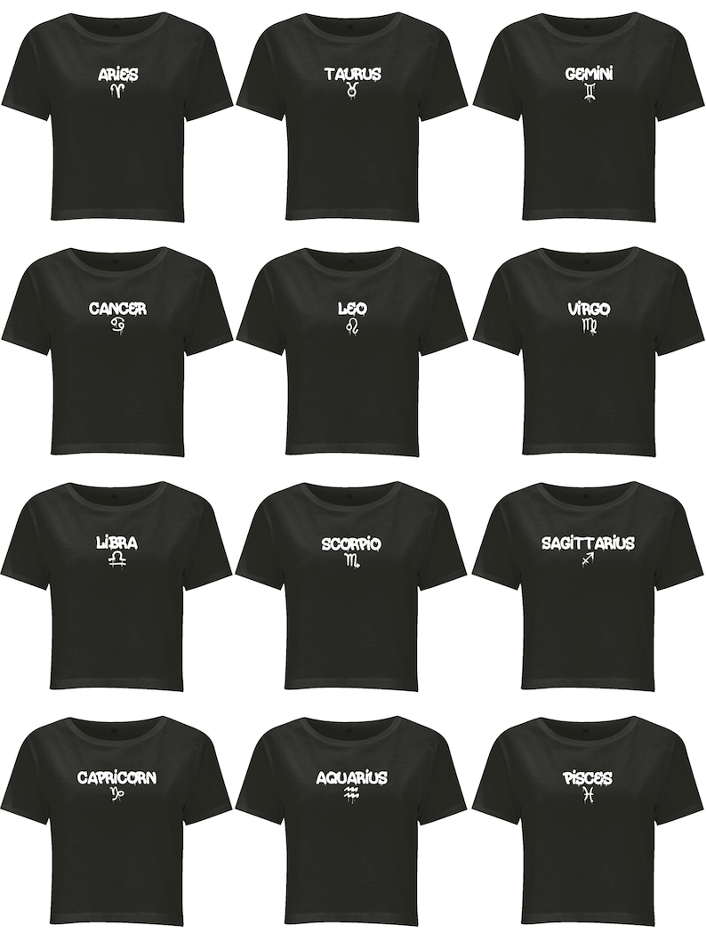 May include: A collection of twelve black short-sleeved crop tops, each featuring a unique white graphic print of a zodiac sign name and its corresponding astrological symbol, including Aries, Taurus, Gemini, Cancer, Leo, Virgo, Libra, Scorpio, Sagittarius, Capricorn, Aquarius, and Pisces.