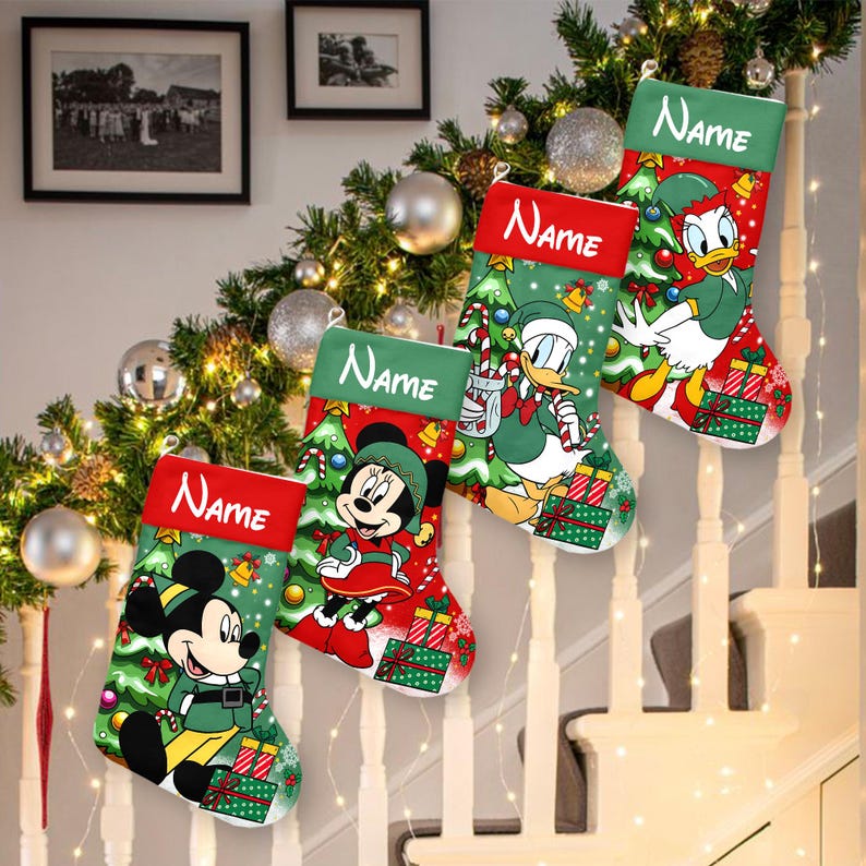 May include: Four Christmas stockings with Disney characters Mickey Mouse, Minnie Mouse, and Donald Duck. Each stocking has a red cuff with the word "Name" in white. The stockings are green with Christmas tree and gift box designs.