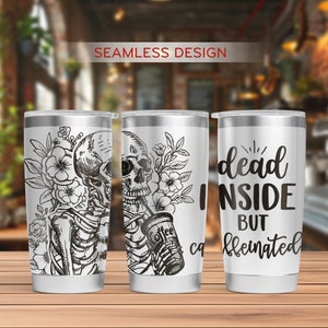 May include: Three stainless steel tumblers with a white background and black designs. The tumbler on the left has a skeleton holding a cup of coffee with flowers behind it. The tumbler in the middle has the same design as the left tumbler. The tumbler on the right has the text "dead inside but caffeinated".