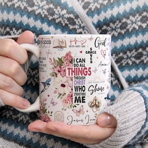 May include: White ceramic mug with a floral design and inspirational Christian quotes, including "I can do all things through Christ who strengthens me" and "Let your light shine".
