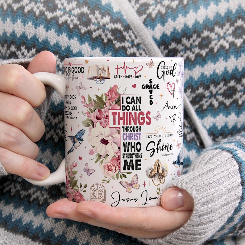 May include: White ceramic mug with a floral design and inspirational Christian quotes, including "I can do all things through Christ who strengthens me" and "Let your light shine".