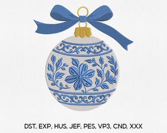 May include: A white and blue embroidered Christmas ornament with a blue bow. The ornament features a floral design with blue leaves and a flower. The ornament has a gold-colored cap. The text "DST, EXP, HUS, JEF, PES, VP3, CND, XXX" is at the bottom.