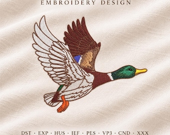 May include: An embroidery design featuring a mallard duck in flight with a green head, yellow bill, and brown, white, and blue wing feathers. The text EMBROIDERY DESIGN appears above, and file formats DST, EXP, HUS, JEF, PES, VP3, CND, XXX are below.