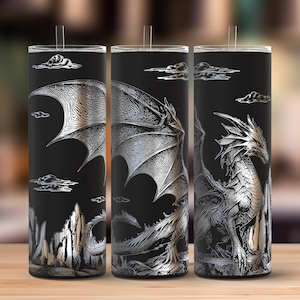 May include: Three black stainless steel tumblers with a silver dragon design. The dragon is depicted with intricate details, wings, and a detailed body. The background features clouds and a mountain range.
