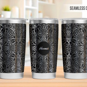 May include: Three stainless steel tumblers with a black and silver mandala design. The text "This is Bullshit" is repeated around the mandala. The middle tumbler has the name "Hannah" in a circle in the center of the mandala.