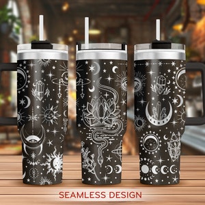 May include: Three stainless steel tumblers with black lids and handles. Each tumbler features a different black and white design with celestial and mystical symbols, including moons, stars, crystals, and a snake. The text "SEAMLESS DESIGN" is printed below the tumblers.