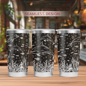 May include: Three stainless steel tumblers with a black and white design of dolphins, seaweed, and bubbles. The tumblers are on a wooden surface. "SEAMLESS DESIGN" is written in white text at the top of the image.