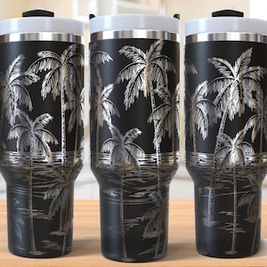 May include: Three black stainless steel travel mugs with a silver palm tree design. The mugs have lids and handles.