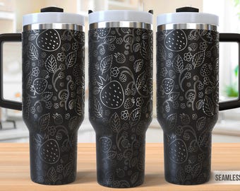May include: Three black stainless steel travel mugs with a white design of strawberries and leaves. The mugs have a black lid and a black handle.