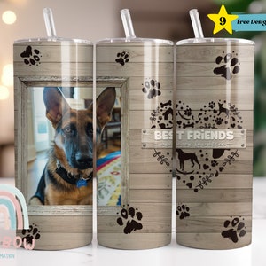 May include: A set of three stainless steel tumblers with a wood grain design. The tumblers feature a paw print design, a photo of a German Shepherd dog, and a heart with the text "Best Friends" surrounded by dog-related icons.