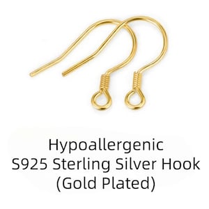 May include: Two gold-plated, hypoallergenic S925 sterling silver earring hooks. The hooks have a curved design with a looped bottom and a coiled section near the loop. The text in the image reads: Hypoallergenic S925 Sterling Silver Hook (Gold Plated).