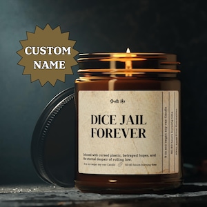 May include: A lit soy wax candle in a brown glass jar with a black lid. The label reads "DICE JAIL FOREVER". The candle is 9 oz and has a 50-60 hour burn time. The text "CUSTOM NAME" is in a starburst shape.