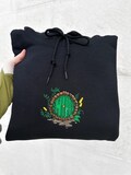 Cozy green door embroidered sweatshirt, cottage hoodie, bookish t-shirt, cozy travel gift for readers product logo