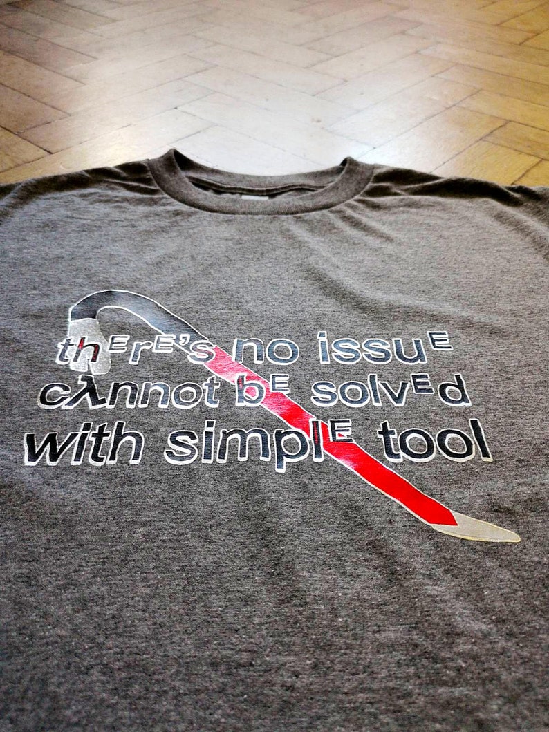 May include: Gray t-shirt with a red and white crowbar graphic and the text "There's no issue cannot be solved with simple tool".