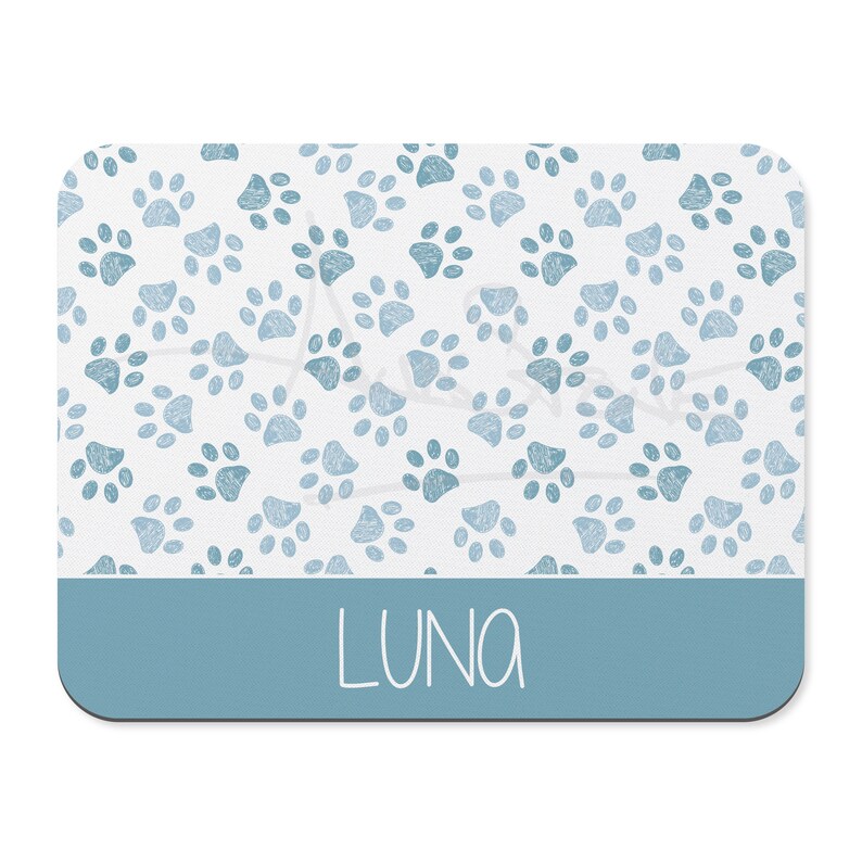 May include: A blue and white mouse pad with a paw print pattern and the name "LUNA" in white text.