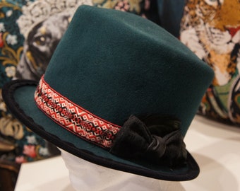 Green felt hat with red bandage with Indian decoration bandage and black feather