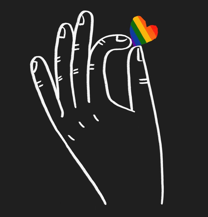 A close-up of the image on a tote bag: a black background with a white outline of a hand holding a small rainbow coloured love heart that is pinched between thumb and forefinger