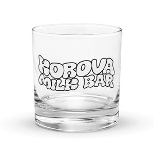 May include: A clear glass tumbler with the text "FOROVA MILK BAR" printed in black on the front.