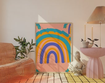 May include: A framed print of a rainbow with a pink, yellow, blue, and green color scheme. The print is hanging on a wall in a room with a pink and white rug, a wicker chair, and a pink side table with a vase of flowers.