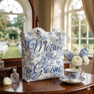 May include: A white ceramic mug with a black handle and the text "But First, Coffee" in a handwritten style. The mug is on a white surface. The mug is approximately 4 inches tall.