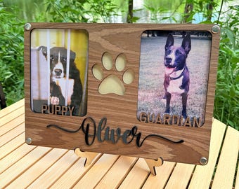 May include: Wooden pet photo frame with two picture slots, a paw print cutout, and the name "Oliver" in script. One photo is labeled "PUPPY", the other "GUARDIAN". The frame is supported by a wooden stand.