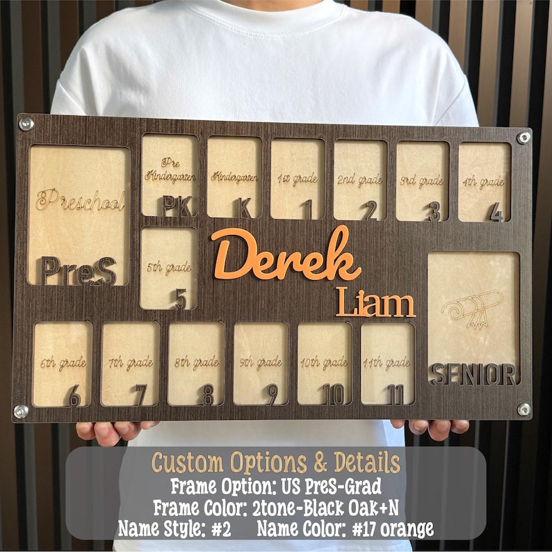 May include: A personalized wooden school years display board with slots for each grade level, from preschool to senior year. The board is dark brown with light wood accents and features the names "Derek" and "Liam" in orange.