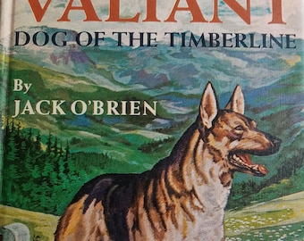 May include: Vintage hardcover book titled "Valiant Dog of the Timberline" by Jack O'Brien. The cover features a German Shepherd dog standing in a mountainous landscape with a wagon and sheep. The title is in orange, and the book is part of the "Famous G&D Dog Stories" series.