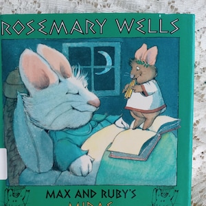 May include: A green book titled "Max and Ruby's Midas. Another Greek Myth" by Rosemary Wells. The cover features a white rabbit with pink ears and a brown mouse with a crown playing a flute.
