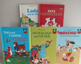 May include: A collection of five vintage children's books featuring classic Disney characters. The books are all in the same style, with colorful covers and illustrations. The titles include "Lady and the Tramp", "101 Dalmatians", "Tod and Copper from "The Fox and the Hound", "Peter Pan and Wendy", and "Pinocchio and His Puppet Show Adventure".