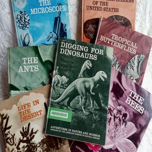 May include: A collection of vintage children's books about nature, including "Under the Microscope", "Reptiles and Amphibians of the United States", "Tropical Butterflies", "The Ants", "Digging for Dinosaurs", "Life in the Desert", and "The Bees".