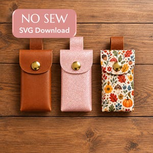 May include: Three rectangular pouches with top flaps and gold-tone snap buttons. One is solid brown, one is light pink with a glitter finish, and one features a colorful autumn pattern of pumpkins, mushrooms, and leaves. Text reads NO SEW SVG Download.