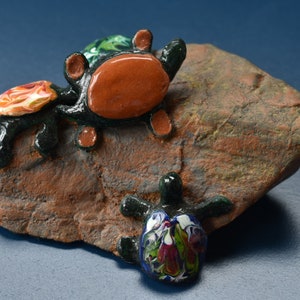 Turtle Rescue.  If a turtle ends up on its back other turtles will come to rescue.  This is a great gift. Turtles sculpture  creatures