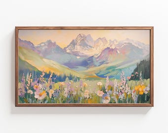 May include: A framed landscape painting featuring a mountain range with snow-capped peaks. The foreground displays a field of wildflowers in shades of pink, yellow, and white. The artwork uses a palette of blues, greens, and yellows.