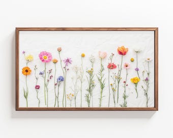 May include: A framed print of a pressed flower arrangement. The flowers are arranged in a row and include pink, red, orange, yellow, and white flowers.