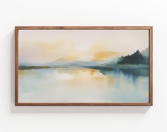 May include: A framed watercolor painting depicting a serene landscape with a lake reflecting a golden sunset. The scene features a distant mountain range and a line of trees along the lakeshore.