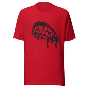 May include: Red t-shirt featuring a black graphic of a dripping vampire mouth with fangs.