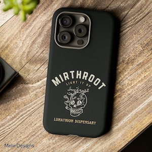 May include: Black phone case with a white skull graphic and the text "Mirthroot Light It Up Lunathion Dispensary".