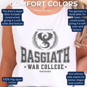 May include: White tank top with a black and grey graphic design featuring a dragon, the text "Basgiath War College", and the words "Riders Quadrant" and "Navarre". The shirt is made of 100% ring-spun cotton.