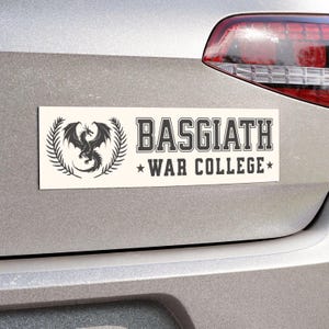 May include: White car magnet with a black dragon and the text "Basgiath War College" in black.